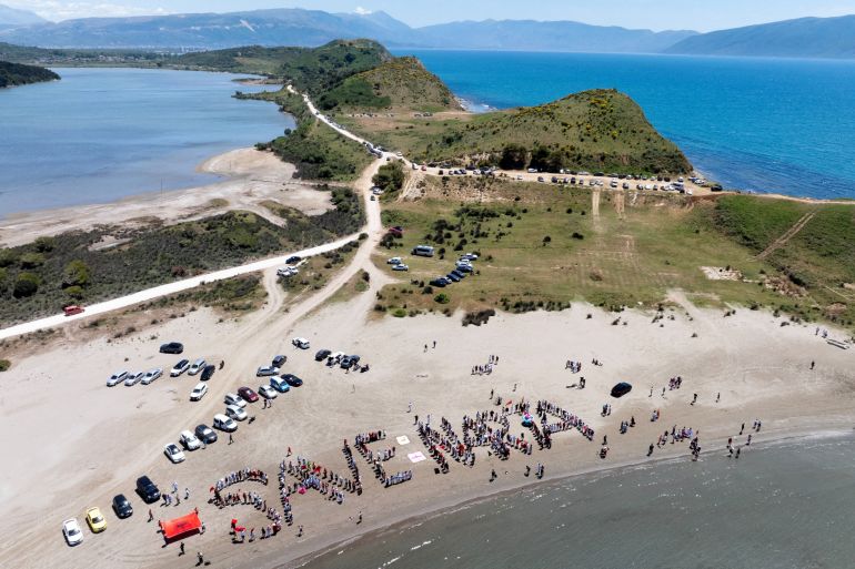 reuters_6a251288-1780814472 A drone view shows people during a protest against a luxury resort, a plan by a company linked to Donald Trump's son-in-law, Jared Kushner, on an environmentally sensitive part of the Adriatic coast, in Zvernec near Vlora, Albania June 6, 2026. REUTERS/Fedja Grulovic TPX IMAGES OF THE DAY