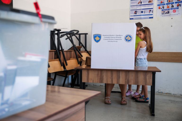 reuters_6a269691-1780913809 Girls wait for their mother to vote during a snap parliamentary election in Pristina, Kosovo, June 7, 2026. REUTERS/Valdrin Xhemaj