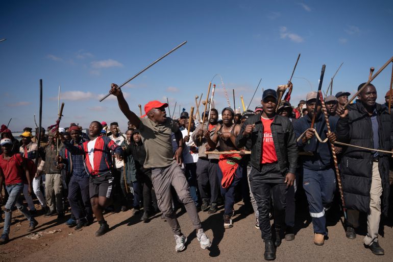 Demonstrators carry sticks during a protest calling for the deportation of undocumented immigrants, as violence against migrants from other African countries increases, in Benoni, east of Johannesburg, South Africa, June 5, 2026. REUTERS/Ihsaan Haffejee