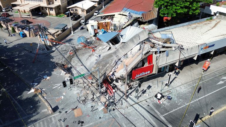 reuters_6a2bcfb0-1781256112 A drone view shows a collapsed building after a magnitude 7.8 quake in General Santos, Mindanao Island, Philippines, June 8, 2026. GenSan DEV/Handout via REUTERS THIS IMAGE HAS BEEN SUPPLIED BY A THIRD PARTY. NO RESALES. NO ARCHIVES. MANDATORY CREDIT TPX IMAGES OF THE DAY REFILE - ADDING VERIFICATION LINES Verification: - Location verified by original file metadata - Business signage, buildings and road layout matched archive imagery - Date verified by local officials