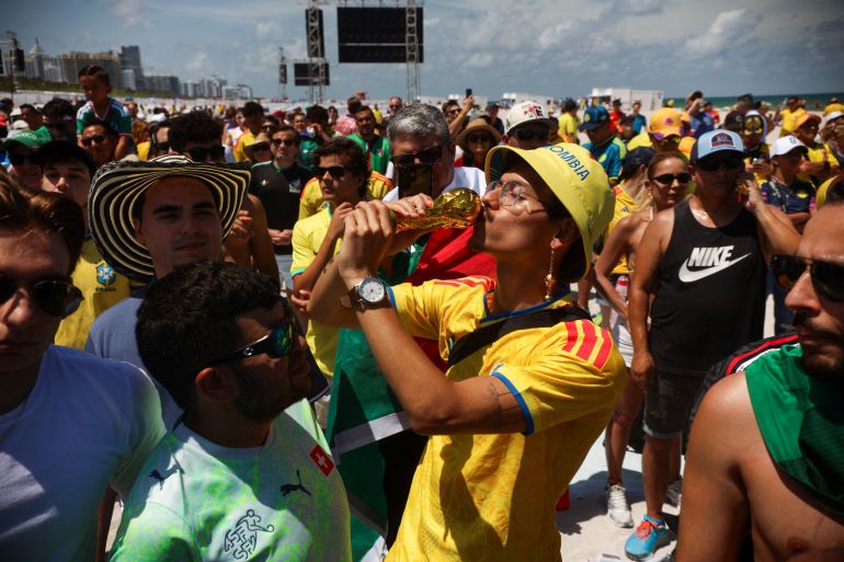reuters_6a2c511a-1781289242 Kevin Ibarra, wearing a Colombia national team jersey, kisses a mock World Cup trophy as people gather in South Beach to watch the first match for the 2026 World Cup, in Miami Beach, Florida, U.S. June 11, 2026. REUTERS/Maria Alejandra Cardona