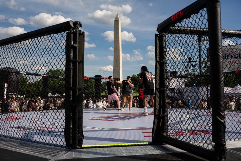 Attendees pose for a photo in an octagon in front of the Washington Monument during the UFC Freedom 250 Fan Fest at the Ellipse in Washington, D.C., U.S., June 13, 2026. REUTERS/Eric lee TPX IMAGES OF THE DAY