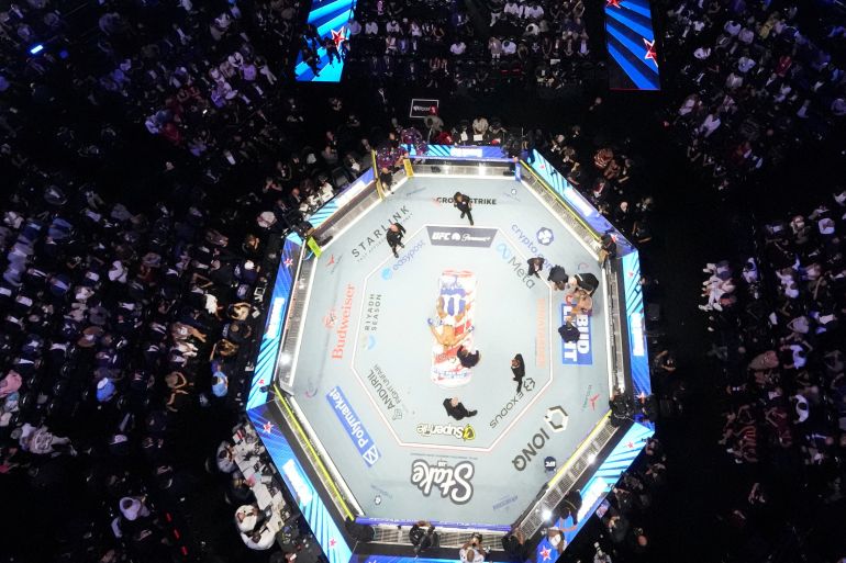 reuters_6a2fa3f1-1781507057 Alex Pereira is attended to as Ciryl Gane lies in the center of the ring during UFC Freedom 250 on the South Lawn of the White House, Monday, June 15, 2026, in Washington. Alex Brandon/Pool via REUTERS