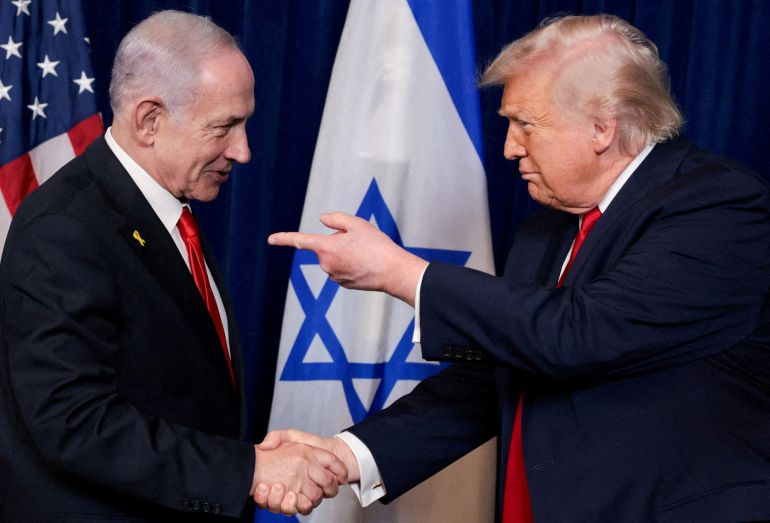 reuters_6a36597d-1781946749 FILE PHOTO: U.S. President Donald Trump points his finger towards Israeli Prime Minister Benjamin Netanyahu as they shake hands during a press conference after meeting at Trump’s Mar-a-Lago club in Palm Beach, Florida, U.S., December 29, 2025. REUTERS/Jonathan Ernst/File Photo/File Photo