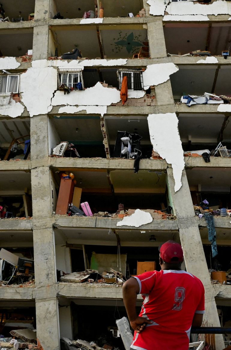 A man looks at a damaged building in the aftermath of earthquakes in La Guaira, Venezuela, June 25, 2026. REUTERS/Maxwell Briceno