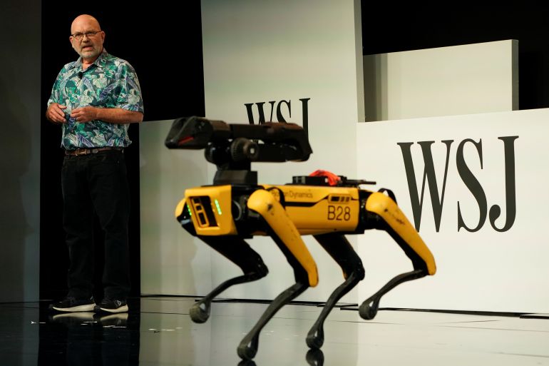 rts2s7s7 Marc Raibert, founder and CEO at Boston Dynamics shows off one of his company's robots at the WSJTECH live conference in Laguna Beach, California