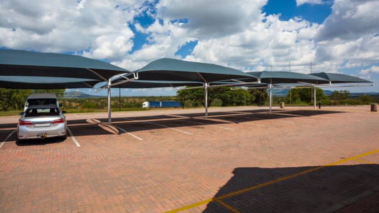 shutterstock_2324237543-1780829774 Parking lot with sun-proof roofs to protect from the sun's rays in South Africa. Car parking with awnings to create shade from the sun in Africa.