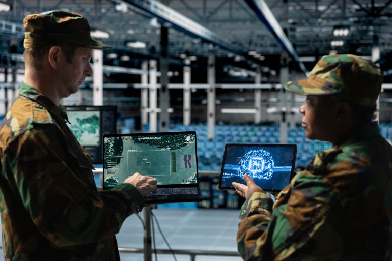shutterstock_2644894273-1781336714 Team of army experts in data center analyzing missiles flight paths with deep learning tools. Military units in server room mapping missile threat zones using AI surveillance platforms