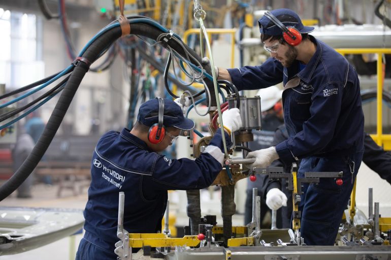 shutterstock_2668133309-1780826352 Almaty, Almaty region, Kazakhstan. June 18, 2024. Workers at the Astana Motors Kazakhstan plant use manual welding to weld car parts.