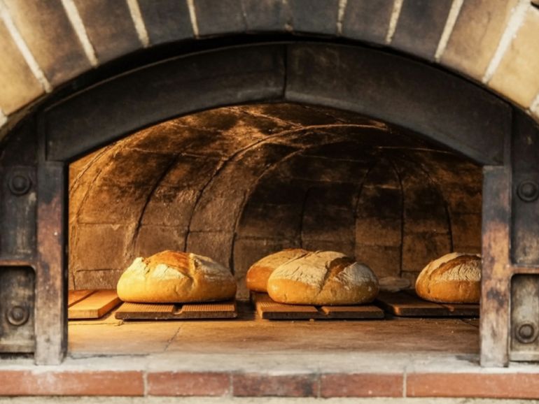 shutterstock_2678930983-1776254990 Sourdough Bread Baking : artisan bread, sourdough loaf, brick oven baking, rustic presentation, homemade bakery, golden crust, traditional cooking, food photography