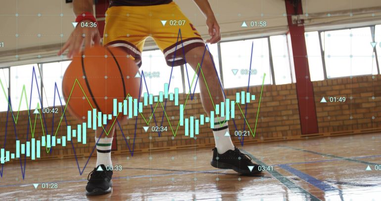 Dribbling basketball player in low stance on court, in yellow shorts, black shoes, data overlays. Athlete, ballhandling, gymnasium, infographics, focus, dynamic, agility