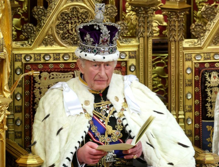 (FILES) Britain's King Charles III, wearing the Imperial State Crown and the Robe of State, sits on the the Sovereign's Throne as he makes his speech in the House of Lords chamber, during the State Opening of Parliament at the Houses of Parliament in London on May 13, 2026. Britain's King Charles III is expected to reveal his personal tax bill in a bid to improve transparency on June 25, 2026, as royal finances come under increasing public scrutiny in Britain. (Photo by Chris Jackson / POOL / AFP)