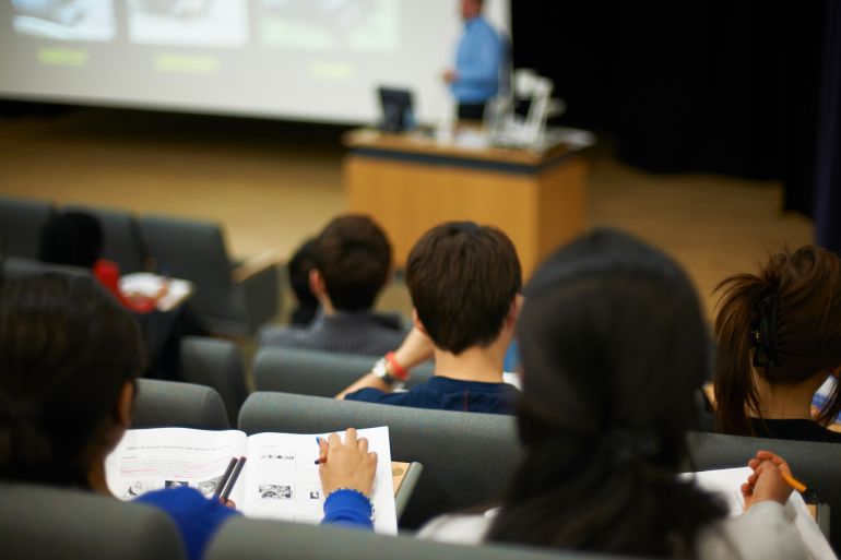 Students reading book in class