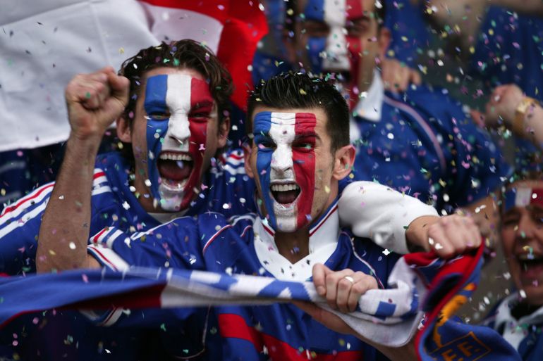 w12w-1781278541 Sports fans with french flags painted on faces, celebrating - stock photo Sports fans with french flags painted on faces, celebrating