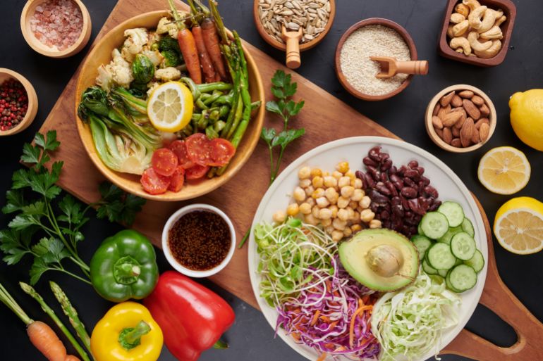 Vegan protein source. Buddha bowl dish, avocado, pepper, tomato, cucumber, red cabbage, chickpea, fresh lettuce salad and walnuts, nuts, beans, . Healthy vegetarian eating, super food. Top view. freepic