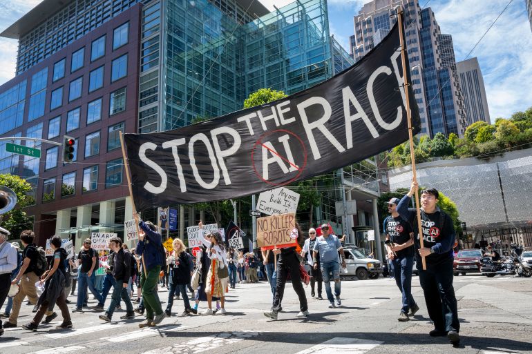 457-1784452819 Demonstrators participate in the "Stop the AI Race" protest march in San Francisco, California, on July 11, 2026. The protestors are making stops outside the offices of OpenAI, Anthropic and Google DeepMind. (Photo by Karl MONDON / AFP)