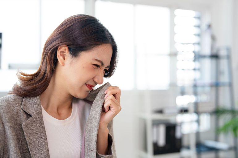 Asian female office lady got problem of stinky and disgusting on clothes.