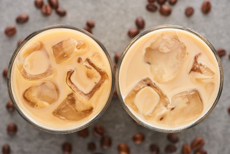 adobestock_281507498-1782939360 top view of fresh ice coffee in glasses and coffee grains on grey background المصدر: أدوبي ستوك