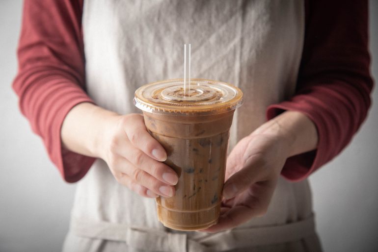 adobestock_296843017-1782939341 barista serving iced coffee in plastic cup المصدر: أدوبي ستوك