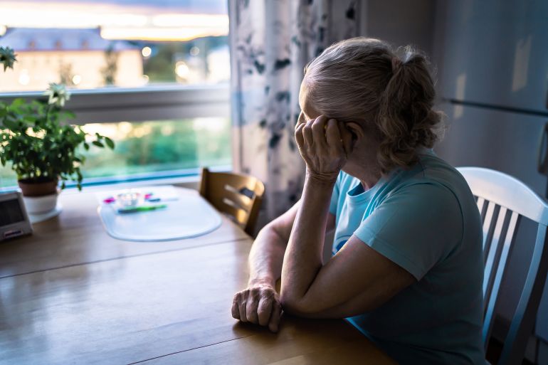 adobestock_528742314-1784563741 Sad old woman. Depressed lonely senior lady with alzheimer, dementia, memory loss or loneliness. Elder person looking out the home window. Sick patient with disorder. Pensive grandma. Widow with grief المصدر: أدوبي ستوك