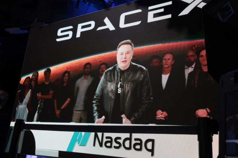 afp_6a2ea9453606-1781442885 NEW YORK, NEW YORK - JUNE 12: Elon Musk, founder and CEO of SpaceX, speaks via video before the ringing of opening bell at the Nasdaq Marketsite at the launch of the company's initial public offering (IPO) on June 12, 2026 in New York City. SpaceX is set to begin trading under the ticker SPCX following what is expected to be the largest initial public offering in history. Elon Musk, who also serves as chief executive of Tesla, could become the world's first trillionaire. In a filing with the Securities and Exchange Commission, the company said it plans to raise $75 billion by selling 555.6 million shares at $135 each. Spencer Platt/Getty Images/AFP (Photo by SPENCER PLATT / GETTY IMAGES NORTH AMERICA / Getty Images via AFP)