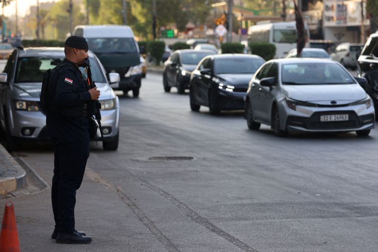 afp_6a43dbb894fa-1782832056 An Iraqi security personnel stands guard along a street in Baghdad on June 28, 2026.