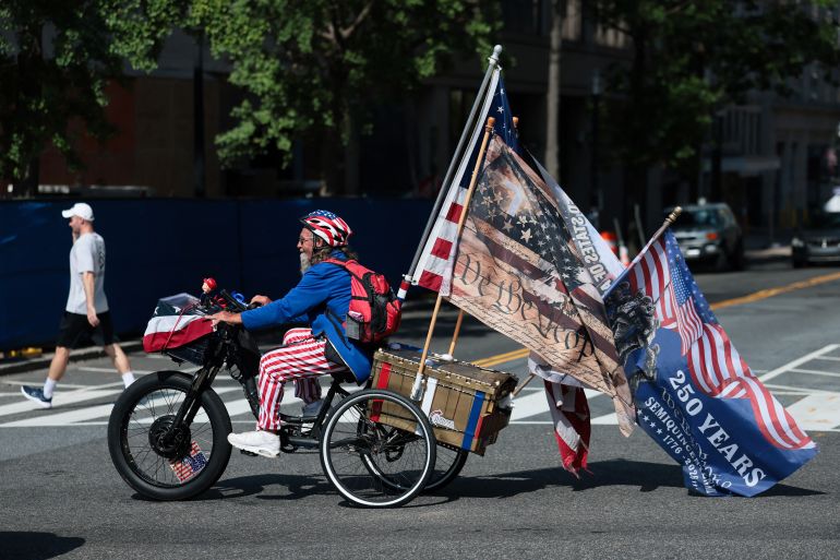 afp_6a4839525e37-1783118162 WASHINGTON, DC - JULY 03: A cyclist wearing patriotic gear is seen as the nation celebrates America's 250th anniversary on July 03, 2026, in Washington, DC. Many Fourth of July festivities have been shortened and some are facing cancellations amid an extreme, multi-day heat wave bringing dangerous triple digit temperatures to much of the eastern United States. Joe Raedle/Getty Images/AFP (Photo by JOE RAEDLE / GETTY IMAGES NORTH AMERICA / Getty Images via AFP)