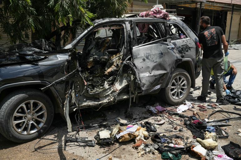 First responders inspect the wreckage of a car reportedly targeted by an Israeli strike in Nabatieh on July 6, 2026.