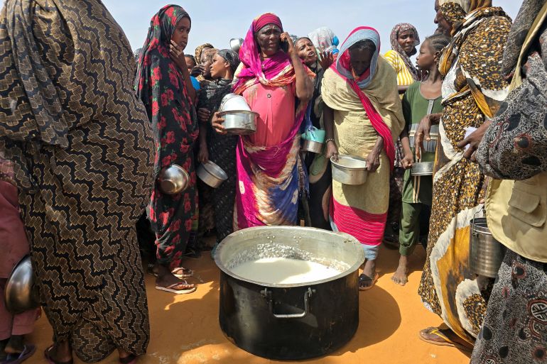 afp_6a5754dbf23f-1784108252 Sudanese women gather for a hot meal in al-Rahmaniyah camp for displaced people, near the city of El-Obeid in the southern Kordofan region on July 7, 2026.