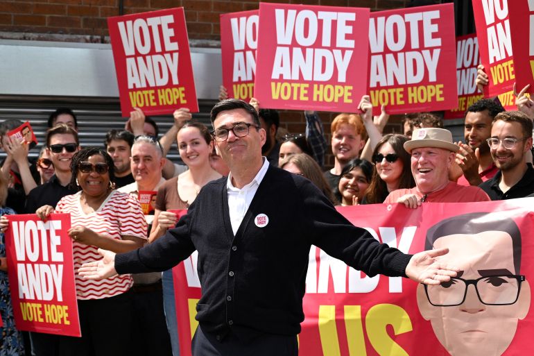 afp_6a59c909c837-1784269065 (FILES) Labour party candidate Andy Burnham addresses supporters outside the Labour party campaign office in Ashton in Makerfield, northwest England, on June 18, 2026, as voters go to the polls to vote in the Makerfield by-election.