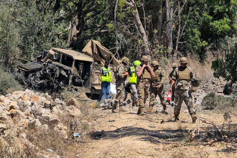 afp_6a5c068a205c-1784415882 Lebanese army soldiers inspect the site of an explosion that targeted their vehicle in the southern Lebanese area of al Mansouri near Tyre on July 18, 2026.