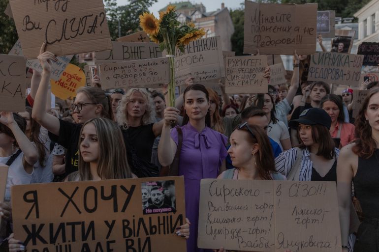 afp_6a5c2a073776-1784424967 Protesters hold placards and chant slogans during a demonstration against Ukraine's President's decision to dismiss Ukraine's Defence Minister Mykhailo Fedorov, and demanding the dismissal of Ukraine's army chief Oleksandr Syrskyi, in Kyiv on July 18, 2026, amid the Russian invasion of Ukraine.