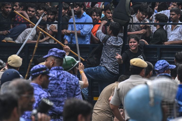 Police personnel baton-charge to disperse activists and supporters of the Cockroach Janta Party (CJP) during a protest demanding the resignation of India's Education Minister Dharmendra Pradhan over alleged NEET exam irregularities in New Delhi on July 20, 2026.
