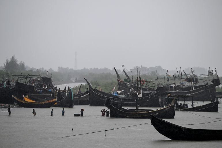 This photograph taken on June 21, 2026 shows fishermen unloading their catch from boats at Teknaf in Bangladesh's Cox's Bazar.
