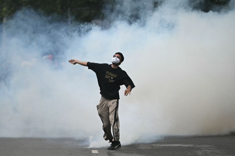 afp_6a5fc9e2dfae-1784662498 A protester throws back a tear gas canister fired by Rapid Action Force (RAF) personnel to disperse supporters of the Cockroach Janta Party (CJP), during a protest demanding the resignation of India's Education Minister Dharmendra Pradhan over alleged NEET exam irregularities in New Delhi on July 20, 2026.