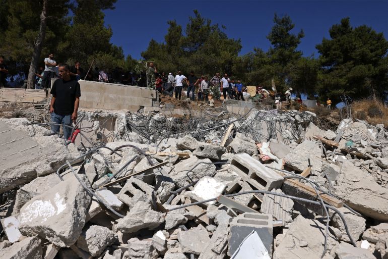 Local residents look for their belongings amid the rubble of Palestinian house that was demolished by Israeli security forces' as it was reportedly built without a permit in the village of Sa'ir, east of Hebron in the occupied West Bank, on July 21, 2026.