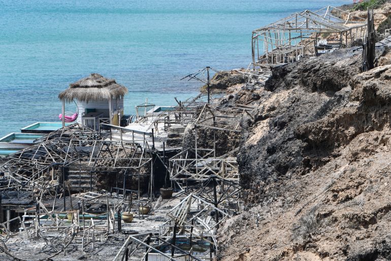 afp_6a6313a636c8-1784877990 This photo shows a general view of a damaged restaurant after being ravaged by a forest fire at Sidi Ali Mekki in the locality of Ghar El Melh on July 22, 2026.