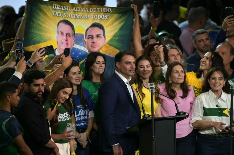 Brazil's right-wing presidential hopeful Flavio Bolsonaro (C) speaks next to his wife Fernanda Bolsonaro (C R) during the launching of his candidacy within the Liberal Party (PL) convention, in Sao Paulo, Brazil on July 25, 2026.
