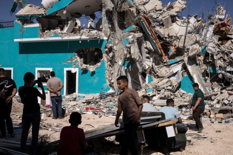 Palestinians gather in front of a building containing shops and apartments that was demolished by Israeli forces in Anza, South of Jenin, Occupied West Bank, on July 27, 2026. (Photo by JOHN WESSELS / AFP)