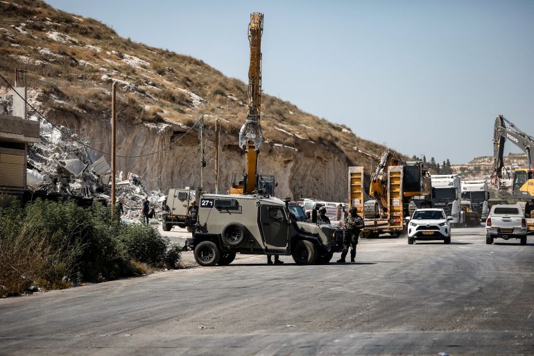 afp_6a67c6e50ad3-1785186021 Israeli forces oversee the demolition of a building containing shops and flats, citing the lack of a building permit, in Anzah, south of the Palestinian city of Jenin, in the northern Israeli-occupied West Bank on July 27, 2026.