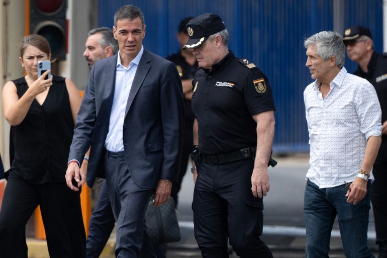 afp_6a6cc58aa3c5-1785513354 Spain's Prime minister Pedro Sanchez (C) and Minister of Interior Fernando Grande Marlaska (R) walk by the Tarajal border fence between Spain's north Africa's Ceuta enclave and Morocco during a visit to manage one the largest migrant crisis on the country's border as thousands of migrants crossed overnight from Morocco on July 31, 2026.