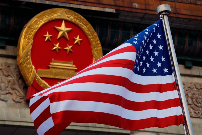 ap_6a0304ae4a750-1778582702 FILE - An American flag is flown next to the Chinese national emblem during a welcome ceremony for visiting U.S. President Donald Trump outside the Great Hall of the People in Beijing on Nov. 9, 2017. (AP Photo/Andy Wong, File)