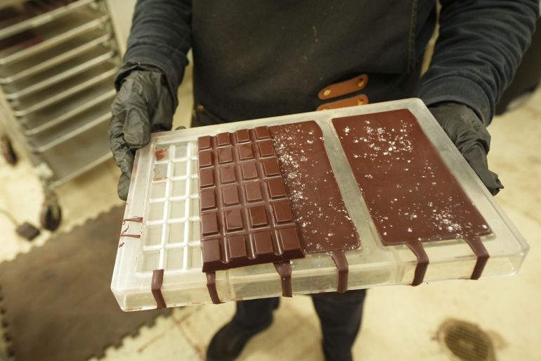 ap_6a4cdad100c14-1783421649 Carolina Quijano, owner of Exquisito Chocolates, holds hand made chocolate bars, Wednesday, Aug. 13, 2025, in the Little Havana neighborhood of Miami. (AP Photo/Marta Lavandier)