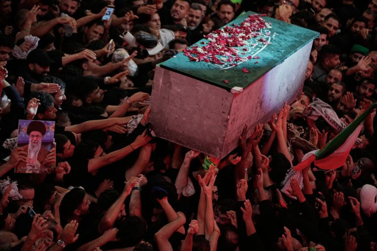 ap_6a4f30393ed12-1783574585 The flower petal-covered coffin of the late Iranian Supreme Leader Ayatollah Ali Khamenei is carried above mourners reaching out to touch it outside the Imam Hussein Shrine in Karbala, Iraq, early Thursday, July 9, 2026. (AP Photo/Khalil Hamra)