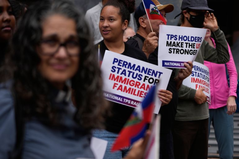 ap_6a5090db47342-1783664859-1 People hold Haitian flags and signs during a rally in support of immigrants living in the United States with temporary protected status, or TPS, Thursday, July 9, 2026, in San Diego. (AP Photo/Gregory Bull)