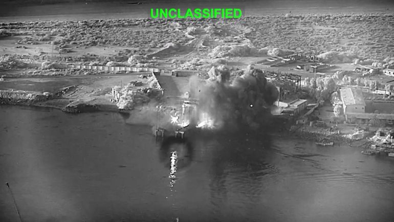 This image from video released by U.S. Central Command, shows an explosion at Bandar Abbas Naval Base, Iran, as three Corsair unmanned surface vessels, also called one-way attack surface drones, fired by the U.S. military, hit the port July 12, 2026. (U.S. Central Command via AP)