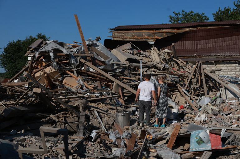 ap_6a59814e0755c-1784250702 A family stands on ruins of their home after a Russian air guided bomb hit their private house in Zaporizhzhia, Ukraine, Thursday, July 16, 2026. (AP Photo/Kateryna Klochko)