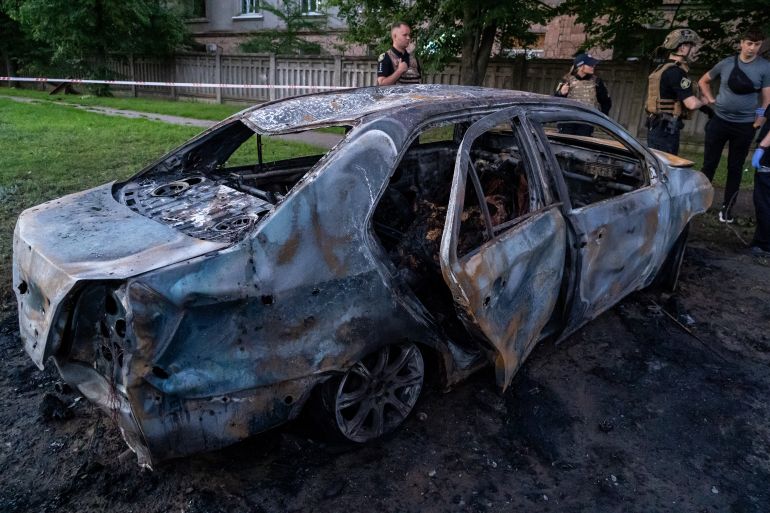 ap_6a5ac0b81589b-1784332472 Police examine the site of a Russian air guided bomb strike that burnt the car and killed the driver in Kharkiv, Ukraine, Friday, July 17, 2026. (AP Photo/Andrii Marienko)