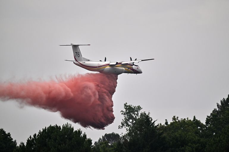 ap_6a678c74e6567-1785171060 A De Havilland Canada DHC-8-400 Dash 8 operated by the French civil defense agency drops fire retardant as wildfires rage near Marcheprime, outside Bordeaux, France, Monday, July 27, 2026. (AP Photo/Emma Da Silva)
