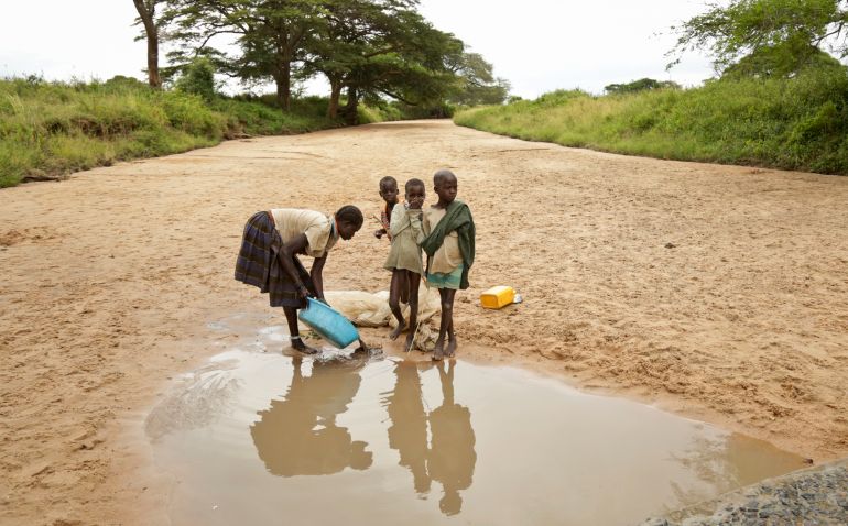 ap_6a6b1a0cce3a5-1785403916 In this photo taken Wednesday, Oct. 18, 2017, a Karamojong woman washes clothes at a small pool of water in a dried-up riverbed in the semi-arid savannah region of Karamoja, in northeastern Uganda. As international leaders meet in Germany for the first major global climate conference since President Donald Trump announced that the U.S. will pull out of the 2015 Paris accord, many in Africa fear they will be harder-hit than most and in Uganda's poorest region Karamoja, the changing climate has brought hunger and bewilderment as traditional coping methods fail. (AP Photo/Adelle Kalakouti)